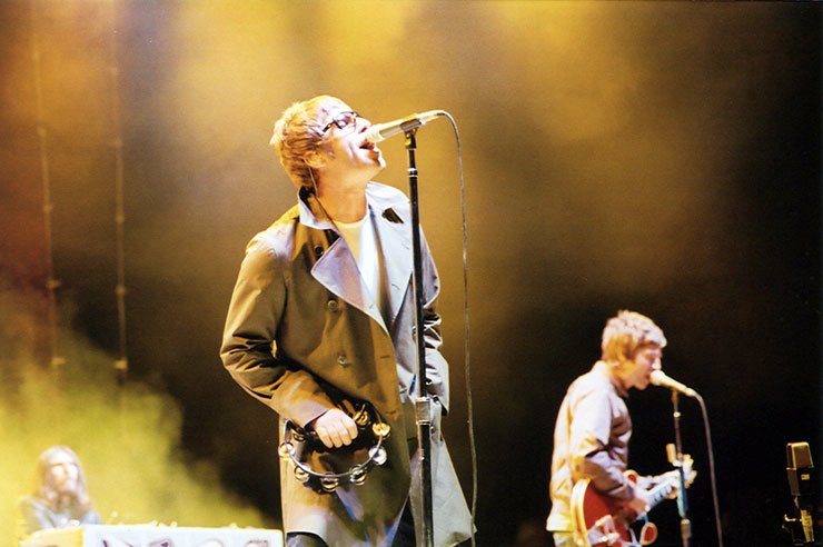Liam and Noel Gallagher performing with Oasis in San Diego in 2005